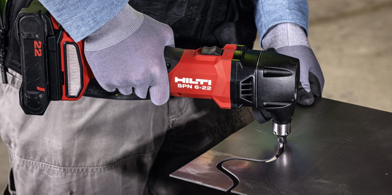 man using cordless nibbler